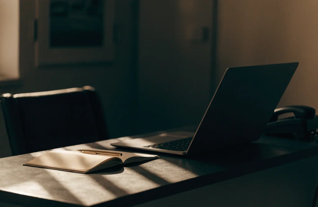 Contact desk with laptop and notebook