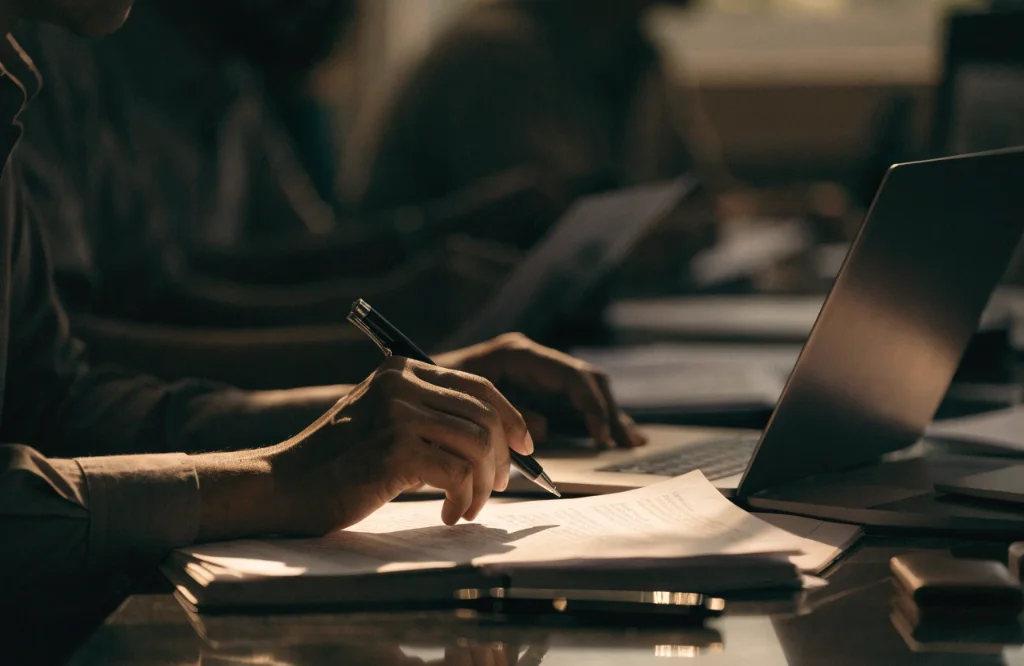 Reporter checking documents and notes at a desk